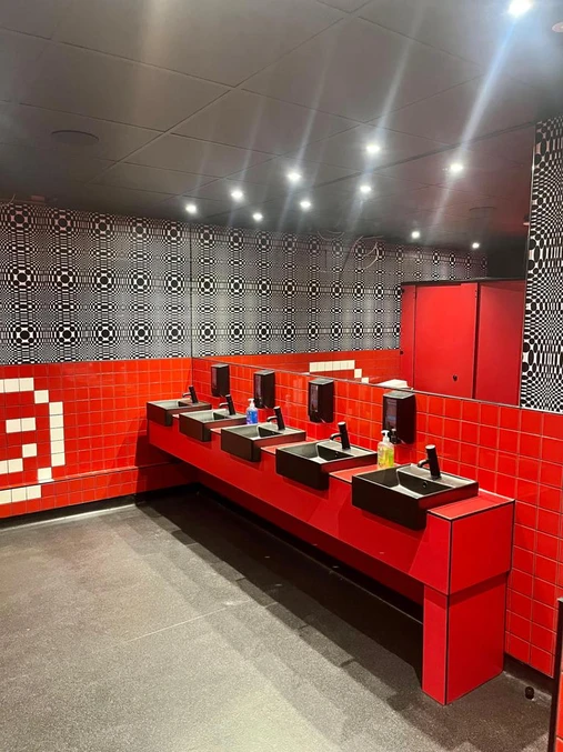 Bold Contrast: Washroom with Red Tiles and Black Sink